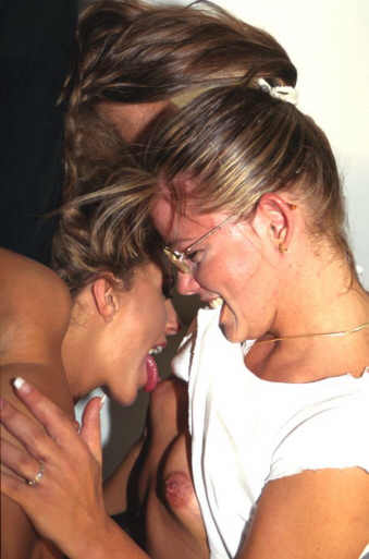 two lesbians holding each other and licking each others breasts