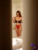 voyeur peep picture i took from behind the door of woman getting undressed and about to take a shower.