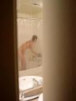 voyeur peep picture i took from behind the door of woman getting undressed and about to take a shower.