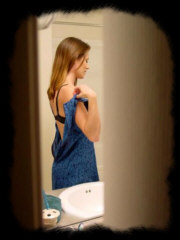 sexy voyeur shot of women stripping in the bathroom.
